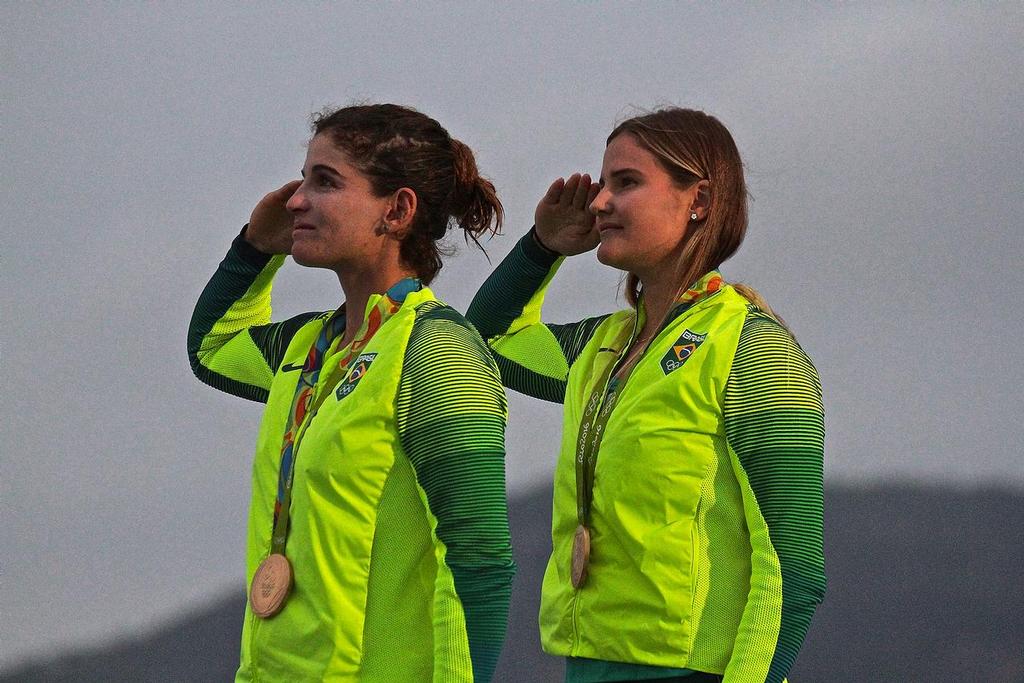 Gold Medalists Martine Grael and Kahena Kunze (BRA) as the Brazilian flag is raised at the 49erFX Medal ceremony - 2016 Sailing Olympics © Richard Gladwell www.photosport.co.nz